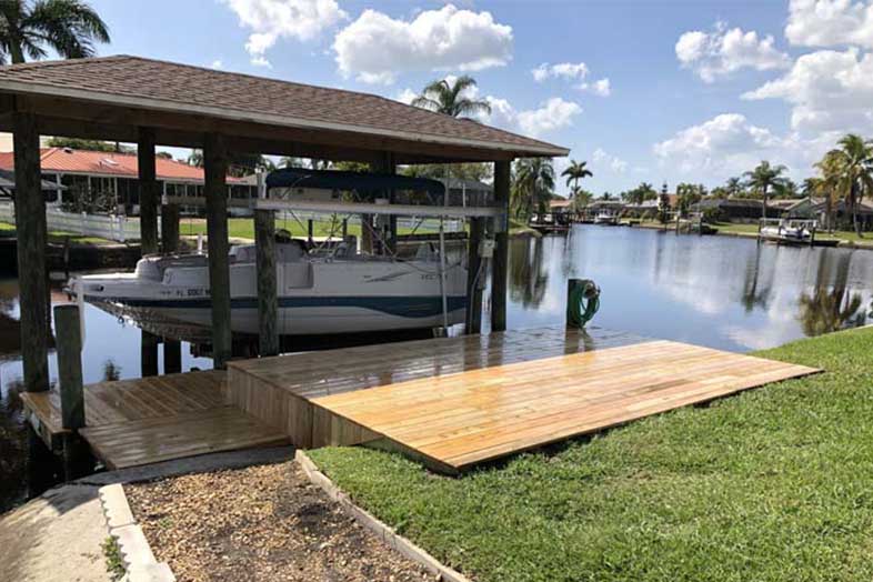 Boat in water in front of boat dock remodeled by SPEC Development