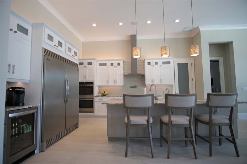 Beautiful kitchen with white cabinets and island, designed by SPEC Development